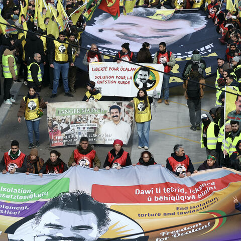 Kurds hold the edges of large banners depicting Kurdistan Worker's Party (PKK) leader Abdullah Ocalan during a demonstration of several thousand people from all around Europe to mark the 26th anniversary of the arrest of PKK founder and to demand his liberation in Strasbourg, Eastern France, on Feb. 15, 2025. 