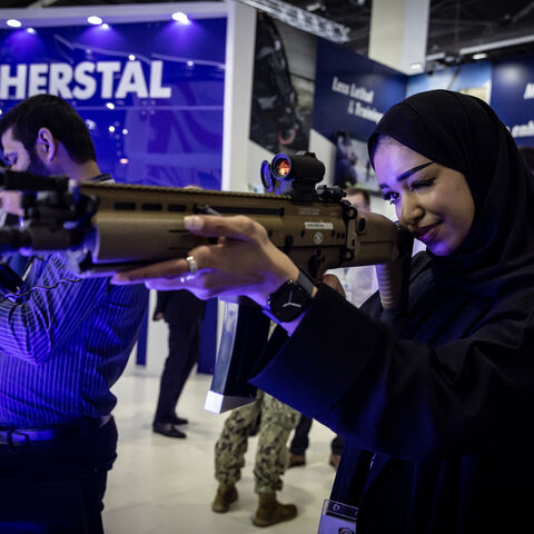 Visitors check weapons during the International Defence Exhibition Idex 2025, on February 17, 2025, in Abu Dhai. (Photo by FADEL SENNA / AFP) (Photo by FADEL SENNA/AFP via Getty Images)