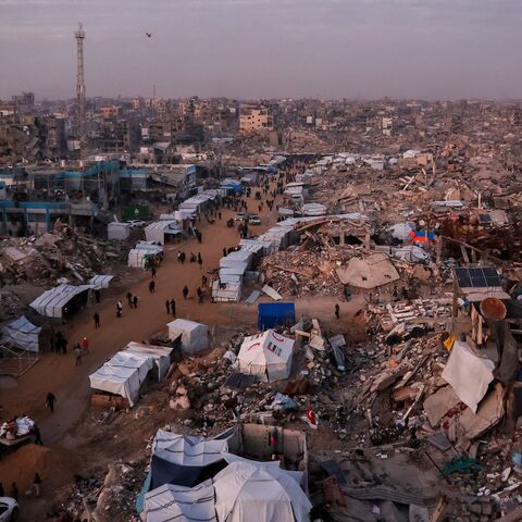 Palestinians walk past tents lining the streets amid the rubble of destroyed buildings in Jabalia, in the northern Gaza Strip on Feb. 18, 2025. 