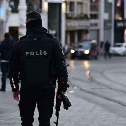 Turkish policemen try to secure the area after a strong explosion of unknown origin shook the busy shopping street of Istiklal in Istanbul, on Nov. 13, 2022. 