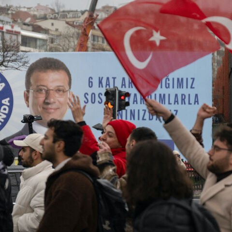 University student wave Turkish national flags as they gather in protest in Besiktas district in Istanbul on March 20, 2025 following Istanbul metropolitan Mayor Ekrem Imamoglu's detention over a corruption probe.