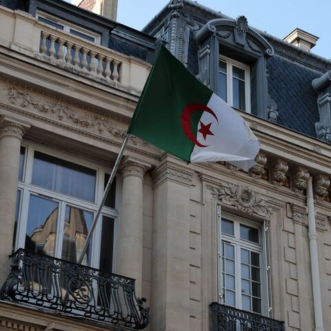 A picture taken on July 23, 2021 shows an Algerian flag fluttering on the facade of the embassy in Paris. - Algeria expressed "deep concern" following press reports that it may have been the target of the Israeli-made Pegasus spyware as it launched a probe. (Photo by Joël SAGET / AFP) (Photo by JOEL SAGET/AFP via Getty Images)