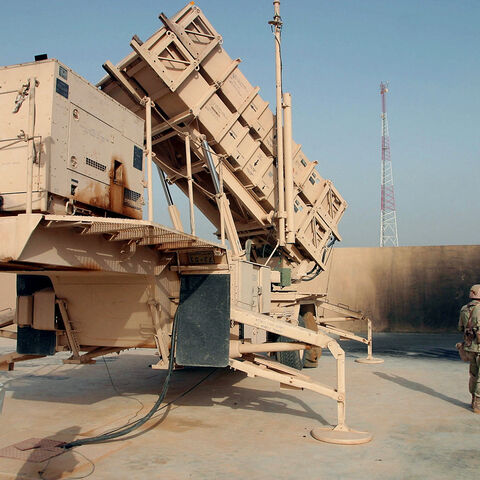 A Kuwaiti reporter gets a close up look at a Patriot missile launcher March 23, 2003, manned by the Kuwait army during a tour in the desert north of Kuwait City.