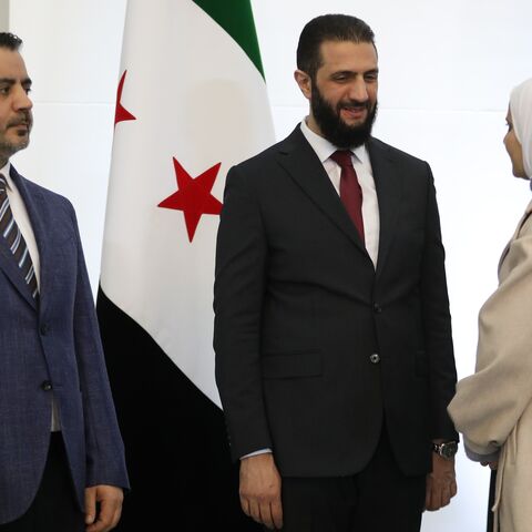 Syrian President Ahmad al-Sharaa (R) and Foreign Minister Asaad al-Shaibani (L) bid farewell to participants at the Syrian National Dialogue Conference.
