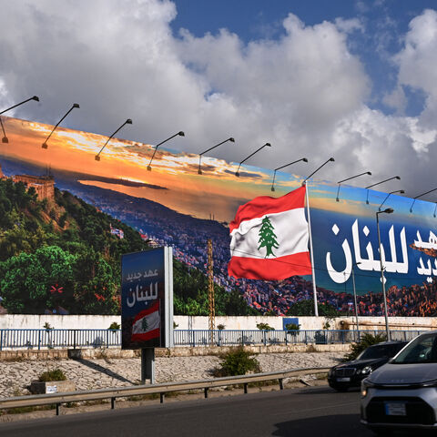 Commuters drive past a newly-installed billboard bearing the image of a Lebanese flag and a statement that reads in Arabic "Lebanon a new era", replacing a Hezbollah billboard, on the road leading to Beirut's Rafic Hariri International airport on April 10, 2025. (Photo by JOSEPH EID / AFP) (Photo by JOSEPH EID/AFP via Getty Images)
