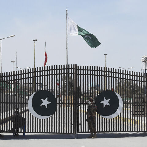 Pakistani soldiers wearing facemasks stand guard at the closed Pakistan-Iran border in Taftan on February 25, 2020 as fears over the spread of the COVID-19 coronavirus escalate following an outbreak in neighbouring Iran. - The Iranian outbreak where at least 15 people have already died -- the highest death toll in any country outside of China -- has aggravated already frayed nerves in neighbouring Afghanistan and Pakistan. (Photo by Banaras KHAN / AFP) (Photo by BANARAS KHAN/AFP via Getty Images)