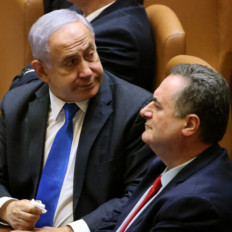 Israeli prime minister Benjamin Netanyahu (L), accompanied by outgoing finance minister Yisrael Katz, on June 13, 2021.