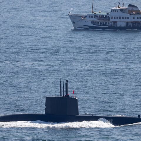 A ferry passes a Turkish Navy submarine navigating the Bosphorus on Sept. 27, 2024, in Istanbul, Turkey.