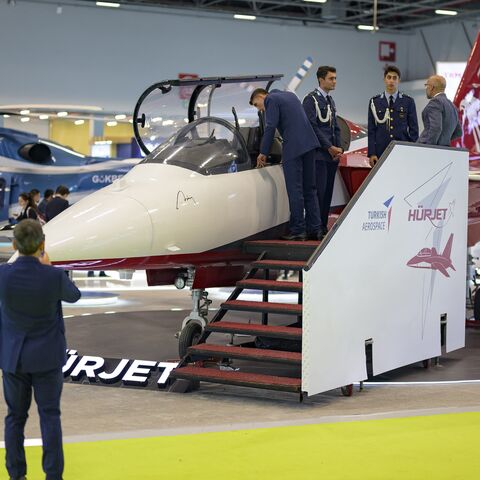 People look at the Hurjet, an advanced jet trainer light attack aircraft, during the opening day of the International Defense and Aerospace exhibition in Istanbul, Oct. 22, 2024.