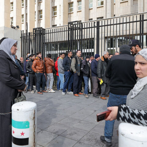 People queue outside the main headquarters of the Central Bank of Syria to exchange US dollars at prices lower than the black market, in Damascus on December 30, 2024. (Photo by ANWAR AMRO / AFP) (Photo by ANWAR AMRO/AFP via Getty Images)