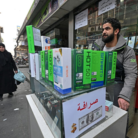 A vendor waits for customers at his mobile shop in the Damascus Tower market, which specializes in the smart phone business, in the Syrian capital on Jan. 12, 2025. 