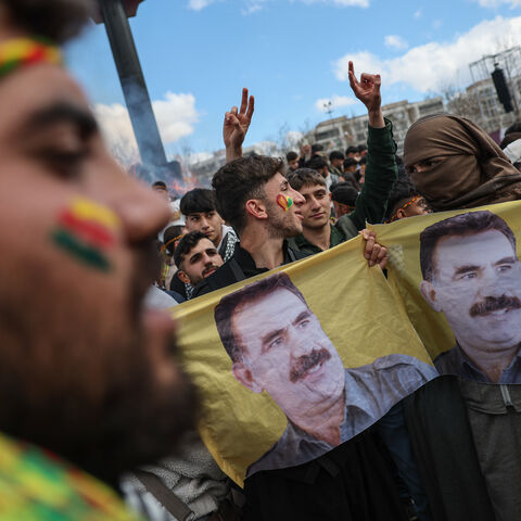 Kurdish youths holds a poster of jailed PKK militant group leader Abdullah Ocalan during Newroz celebrations on March 21, 2025 in Diyarbakir, Turkey. 