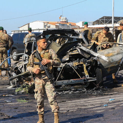 Lebanese soldiers inspect the site near a burnt-out vehicle reportedly hit by an Israeli strike in Ghazieh, near Sidon, on April 18, 2025. Lebanon's health ministry said an Israeli strike on April 18 hit a vehicle near the southern coastal city of Sidon, killing one person. Despite a November 27 ceasefire that sought to halt more than a year of all-out war between Israel and Hezbollah, Israel has continued to carry out near-daily strikes in Lebanon. (Photo by Mahmoud ZAYYAT / AFP) (Photo by MAHMOUD ZAYYAT/A