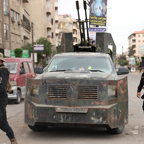 Members of Syria's security forces stand guard at a checkpoint in Ashrafiyat Sahnaya, near Damascus, after days of deadly sectarian clashes involving the Druze, May 1, 2025.