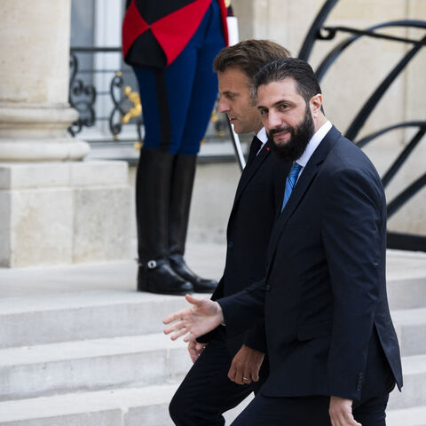 France s President Emmanuel Macron (R) welcomes Syrian interim President Ahmed al-Sharaa upon his arrival for their meeting at the Elysee presidential palace in Paris on May 7, 2025. Syrian interim President Ahmed al-Sharaa arrived in Paris on May 7, state media reported, on his first visit to Europe since overthrowing longtime ruler Bashar al-Assad in December. (Photo by Magali Cohen / Hans Lucas / Hans Lucas via AFP) (Photo by MAGALI COHEN/Hans Lucas/AFP via Getty Images)