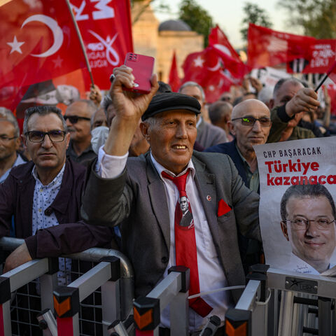 People hold Turkish flags and placards reading "winner Turkey" as they take part in a demonstration against the detention of the Mayor of Istanbul, Ekrem Imamoglu, organized by the country's main opposition, the Republican People's Party (CHP), at Beyazid Square, in Istanbul, May 7, 2025. 