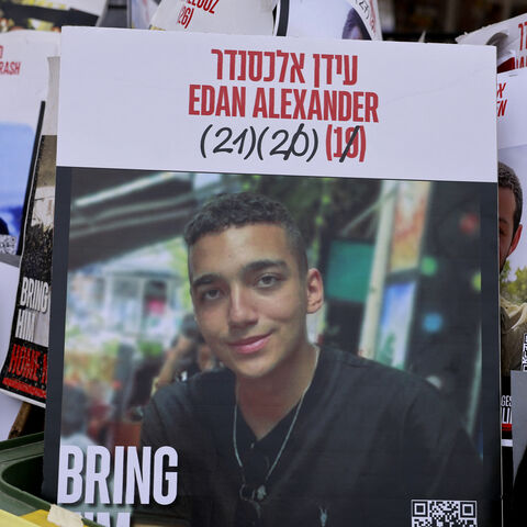 A sign showing the face of Israeli-US hostage Edan Alexander (C), who has been held by Hamas in the Gaza Strip since October 2023, is pictured among portraits of other Israelis held captive in Gaza at Hostages Square, Tel Aviv, May 12, 2025.