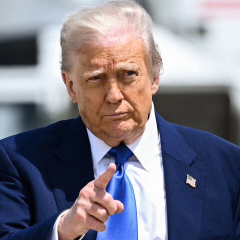 US President Donald Trump gestures as he walks to board Air Force One at Joint Base Andrews in Maryland, May 12, 2025.