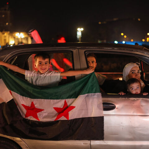 People celebrate in Damascus' Omeyyad square after US President Donald Trump's decision to lift sanctions in Syria, on May 13, 2025. (Photo by Abdulaziz KETAZ / AFP) (Photo by ABDULAZIZ KETAZ/AFP via Getty Images)