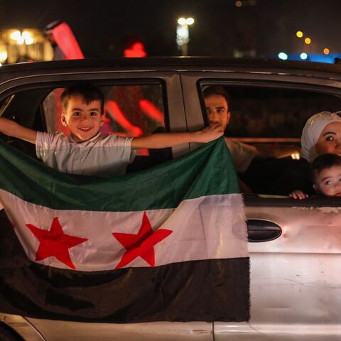 People celebrate in Damascus' Omeyyad Square after US President Donald Trump's decision to lift sanctions in Syria, on May 13, 2025.