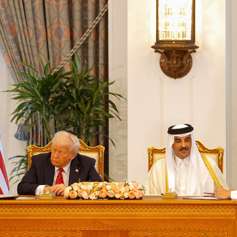 QATAR-US-DIPLOMACY Qatar's Emir Sheikh Tamim bin Hamad al-Thani (C-R) and US President Donald Trump (C-L) watch as US Secretary of Defense Pete Hegseth (L) and Qatar's Deputy Prime Minister and Minister of State for Defence Affairs Sheikh Saoud bin Abdulrahman Al-Thani (R) sign documents during a signing ceremony at the Royal Palace in Doha on May 14, 2025. (Photo by Karim JAAFAR / AFP) (Photo by KARIM JAAFAR/AFP via Getty Images)