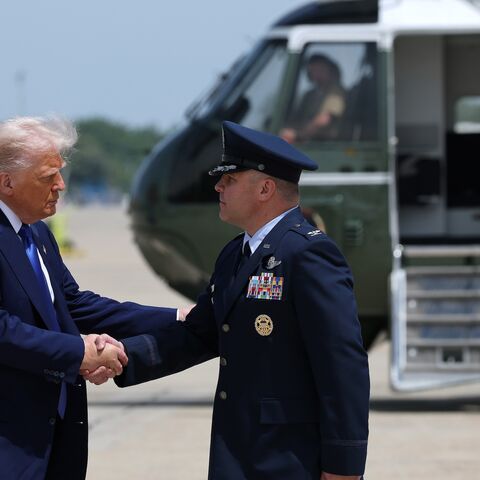President Donald Trump is greeted by Air Force Col. Paul R. Pawluk as he arrives to board Air Force One on May 12, 2025, at Joint Base Andrews, Maryland.