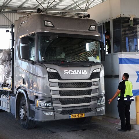 A truck carrying humanitarian aid drives through the Kerem Shalom crossing between southern Israel and the Gaza Strip, on May 22, 2025