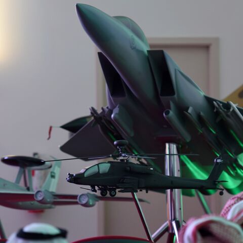 A member of Saudi security forces stands next to a replica of a fighter jet of the Saudi armed forces during the daily media briefing on Operation Decisive Storm, the Saudi-led coalition carrying out air strikes against Shiite Huthi militia in neighboring Yemen, on April 2, 2015 at the Air Base of the Saudi capital Riyadh.