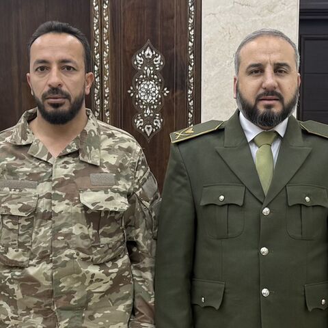 Ahmad al-Hayes (L) is seen with interim Syrian Defense Minister Murhaf Abu Qasra. — X