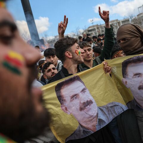 Kurdish youths holds a poster of jailed PKK militant group leader Abdullah Ocalan during Newroz celebrations, on March 21, 2025, in Diyarbakir, Turkey.