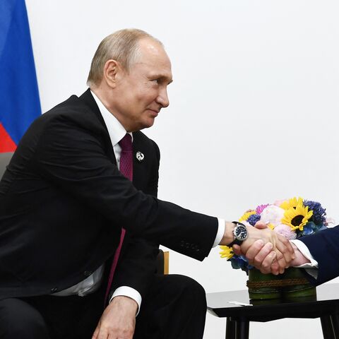 US President Donald Trump (R) attends a meeting with Russia's president, Vladimir Putin, during the G20 summit in Osaka on June 28, 2019.