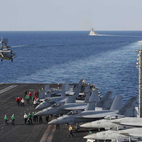 In this handout photo provided by the US Navy, the aircraft carrier USS Abraham Lincoln transits the Strait of Hormuz as an MH-60S Sea Hawk helicopter from the Nightdippers of Helicopter Sea Combat Squadron 5 lifts off from the flight deck, Nov. 19, 2019.