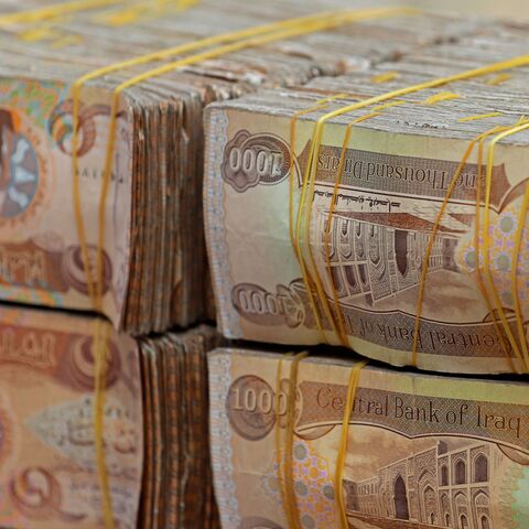 Stacks of Iraqi dinars are seen at currency exchange shop in Baghdad on February 14, 2023. - Iraq nudged up the value of its local currency against the dollar in an effort to stabilise the dinar after tougher foreign transfer regulations sent its value fluctuating. The government adopted a new official exchange rate, fixing it at 1,300 dinars to the US dollar instead of 1,470, the prime minister's office said. (Photo by Murtaja LATEEF / AFP) (Photo by MURTAJA LATEEF/AFP via Getty Images)