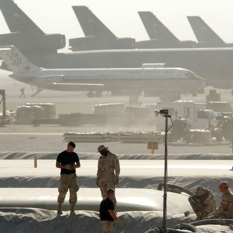 Members of the Petroleum Oils and Lubricants squadron at the 379th Air Expeditionary Wing take a break from replacing a 50,000-gallon fuel bladder in support of Operation Enduring Freedom, on Dec. 30, 2002, in Al Udeid, Qatar.