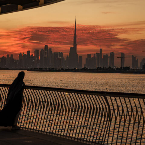 A woman looks on from Creek Harbout at the Dubai skyline with Burj Khalifa, the world's largest building (C) on Feb. 5, 2025.