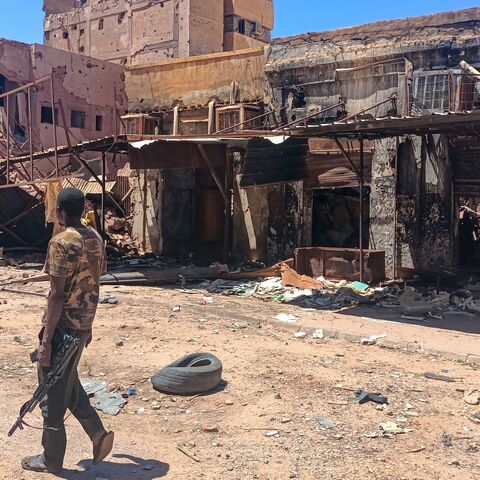 A fighter loyal to the army patrols a market area in Khartoum on March 24, 2025.