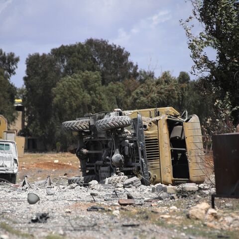 Debris and military vehicles lie at the scene of an Israeli strike in Syria's southern Hama governorate on April 3, 2025.