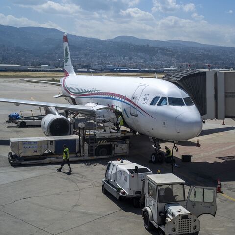 Ground staff prepare a Middle East Airlines flight for departure on the tarmac at Rafic Hariri International Airport in Beirut on May 2, 2025.