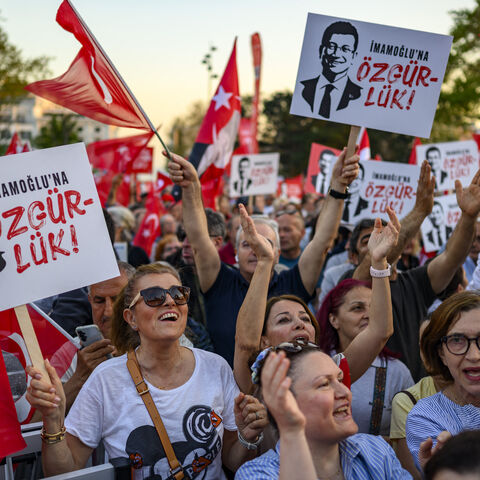 Protesters hold Turkish flags and placards reading 'Freedom for Imamoglu' as they take part in a demonstration against the detention of the Mayor of Istanbul, Ekrem Imamoglu, organized by the country's main opposition, the Republican People's Party (CHP), at Beyazid Square, in Istanbul, May 7, 2025.