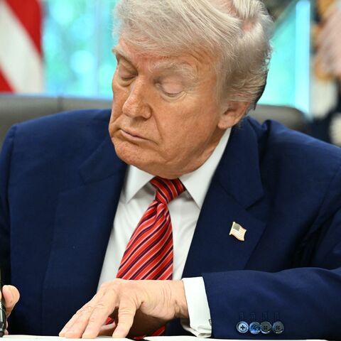 US President Donald Trump signs executive orders in the Oval Office of the White House in Washington, DC, on May 23, 2025.