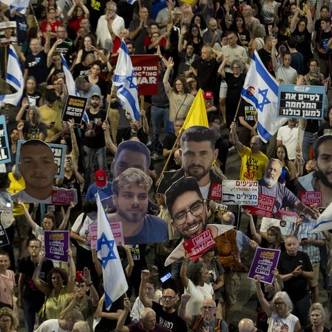 Protesters hold signs and photos of hostages held in the Gaza Strip by Hamas during a rally calling for a hostage deal, May 31, 2025 in Tel Aviv, Israel.