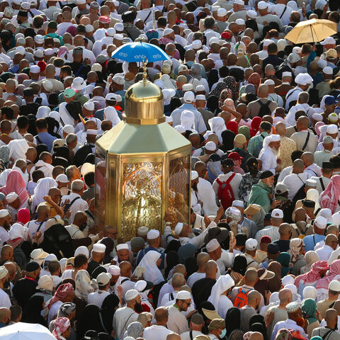 Muslim worshippers make their way towards the Kaaba, Islam's holiest shrine, at the Grand Mosque complex in in the holy city of Mecca to take part in morning prayers on the first day of Eid Al-Adha, the feast of the sacrifice, early on June 6, 2025.