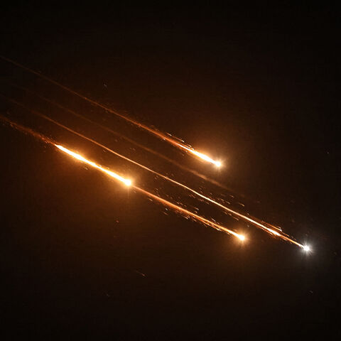 Debris of missiles fired from Iran toward Israel leave trails in the night sky over Nablus in the occupied West bank after being intercepted on June 13, 2025. (Photo by Zain JAAFAR / AFP) (Photo by ZAIN JAAFAR/AFP via Getty Images)