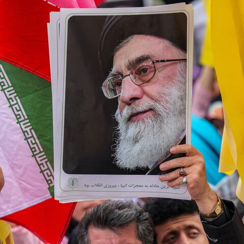 A picture of Iran's supreme leader, Ayatollah Ali Khamenei, is held aloft at a rally on Enghelab (Revolution) Square, Tehran, June 14, 2025.