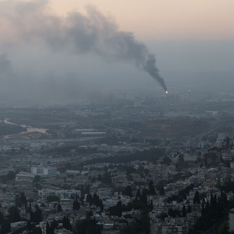Smoke billows from a site that was hit by an Iranian missile strike in the city of Haifa early on June 16, 2025.