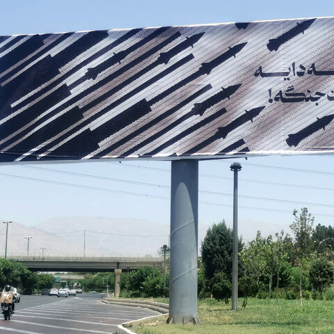 Commuters drive past an anti-Israel billboard in Tehran, on June 22, 2025. President Donald Trump said the US military carried out strikes on June 22 on three Iranian nuclear sites and that Tehran "must now agree to end this war", following days of speculation over whether the United States would join its ally Israel's bombing campaign. (Photo by ATTA KENARE / AFP) (Photo by ATTA KENARE/AFP via Getty Images)