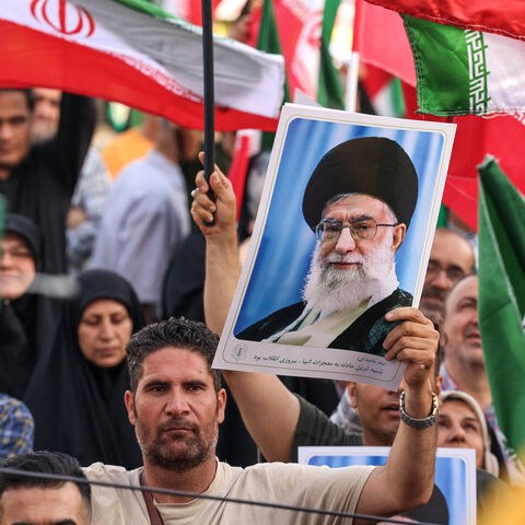An Iranian man holds a portrait of supreme leader Ayatollah Ali Khamenei as people celebrate a ceasefire between Iran and Israel at Enghlab Square in the capital Tehran on June 24, 2025.