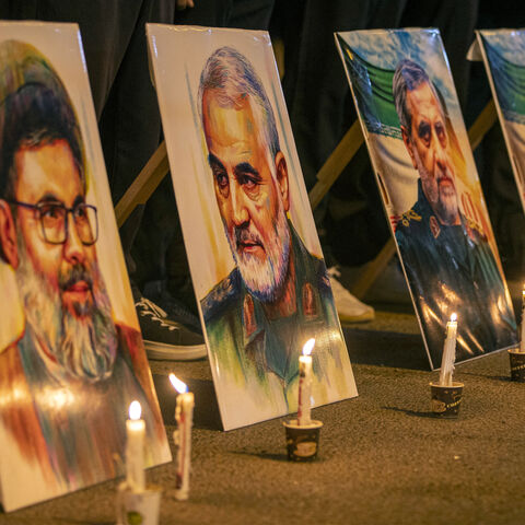 Pictures of Lebanese Hezbollah's slain leader Hashem Safieddine (L) and Iran's Islamic Revolutionary Guard Corps (IRGC) commander Qassem Soleimani (2nd-L) and others during a memorial vigil mourning slain members of the IRGC and scientists killed in recent Israeli airstrikes, outside the Iranian embassy headquarters in Baghdad on June 28, 2025. Iran held a state funeral service on June 28 for around 60 people, including its military commanders, killed in its war with Israel, after Tehran's top diplomat cond