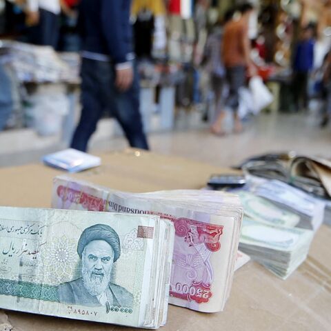 Iranian rial banknotes bearing a portrait of the late founder of the Islamic Republic of Iran, Ayatollah Ruhollah Khomeini, sit on the stand of an Iraqi money dealer on June 19, 2014, in Arbil, Iraq.