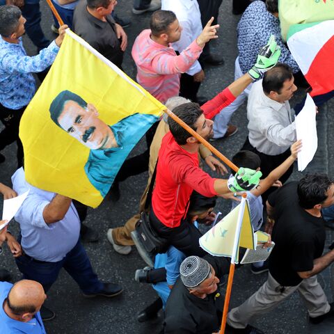 An Iraqi Kurdish man holds a flag with the portrait of jailed Kurdish militant leader Abdullah Ocalan during a demonstration in the northern Iraqi Kurdish city of Sulaimaniyah on Oct. 10, 2019 against the Turkish offensive in northeastern Syria.